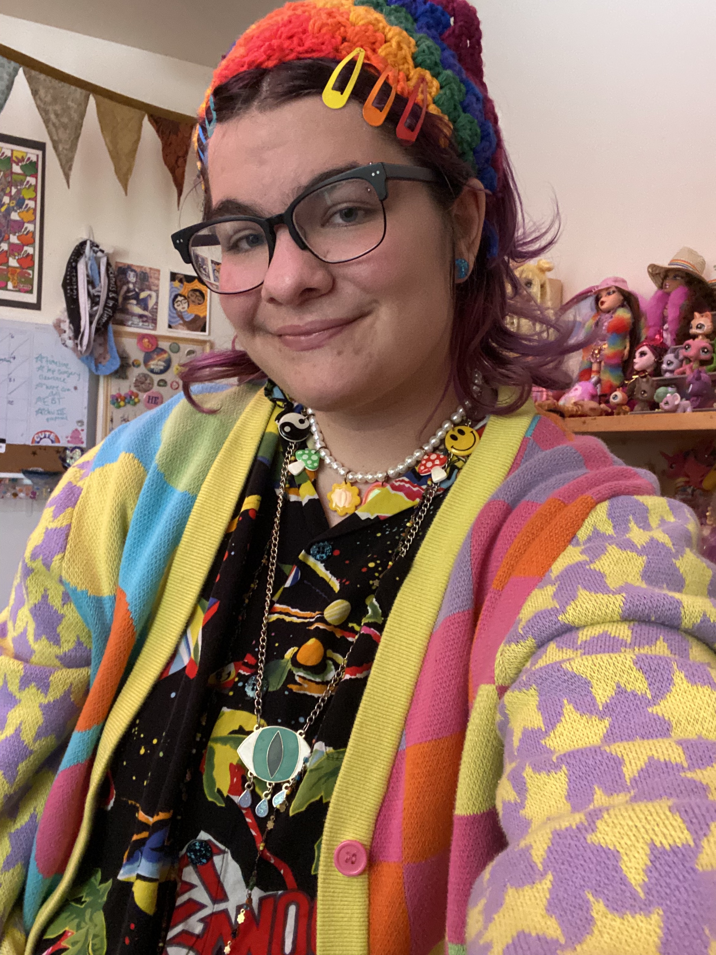 Portrait of the artist Xander Rabii. He is smiling and wearing a colorful jacket.